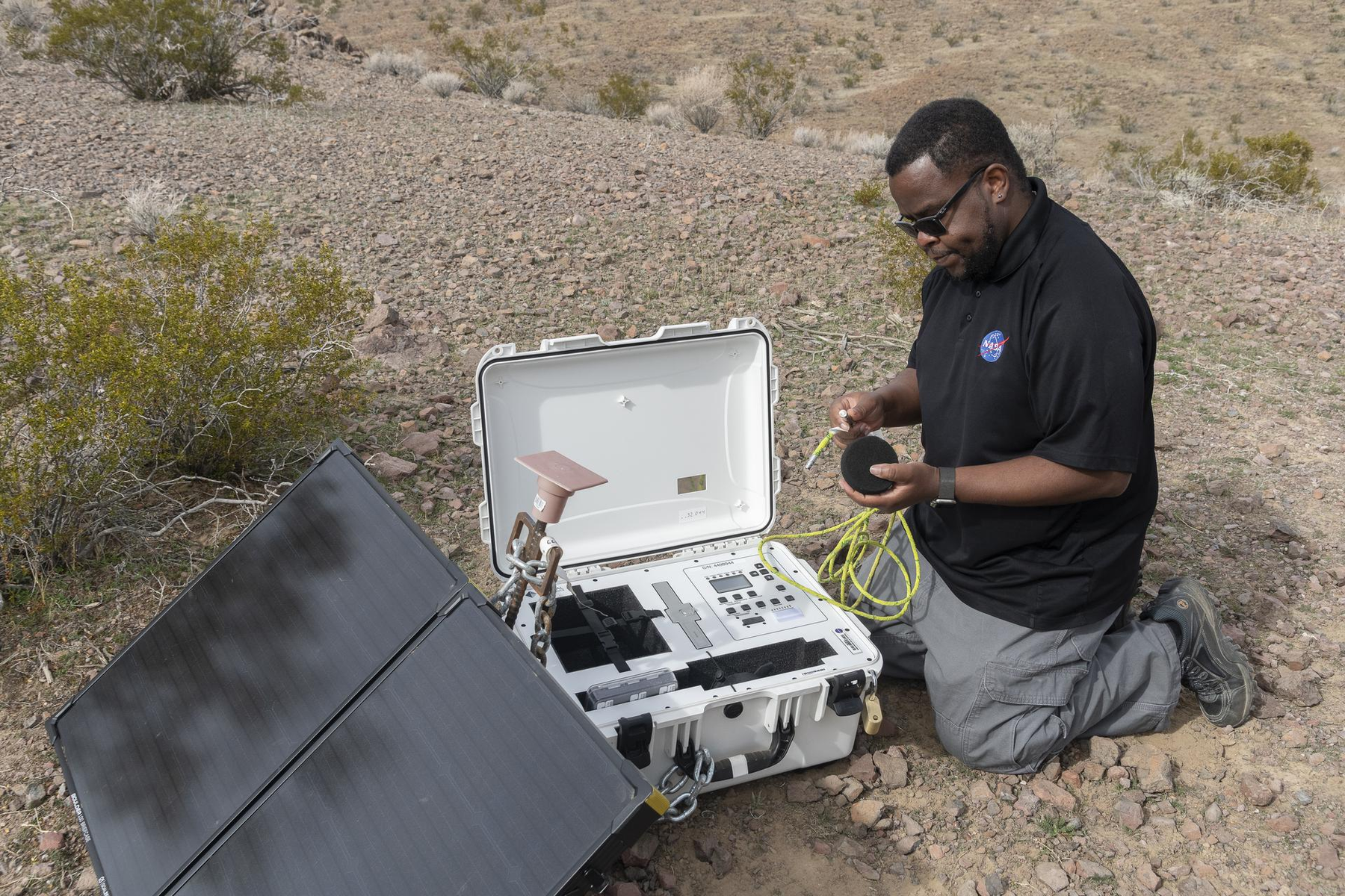NASA researcher setting up a ground recording system in the California desert during earlier acoustic-test preparations