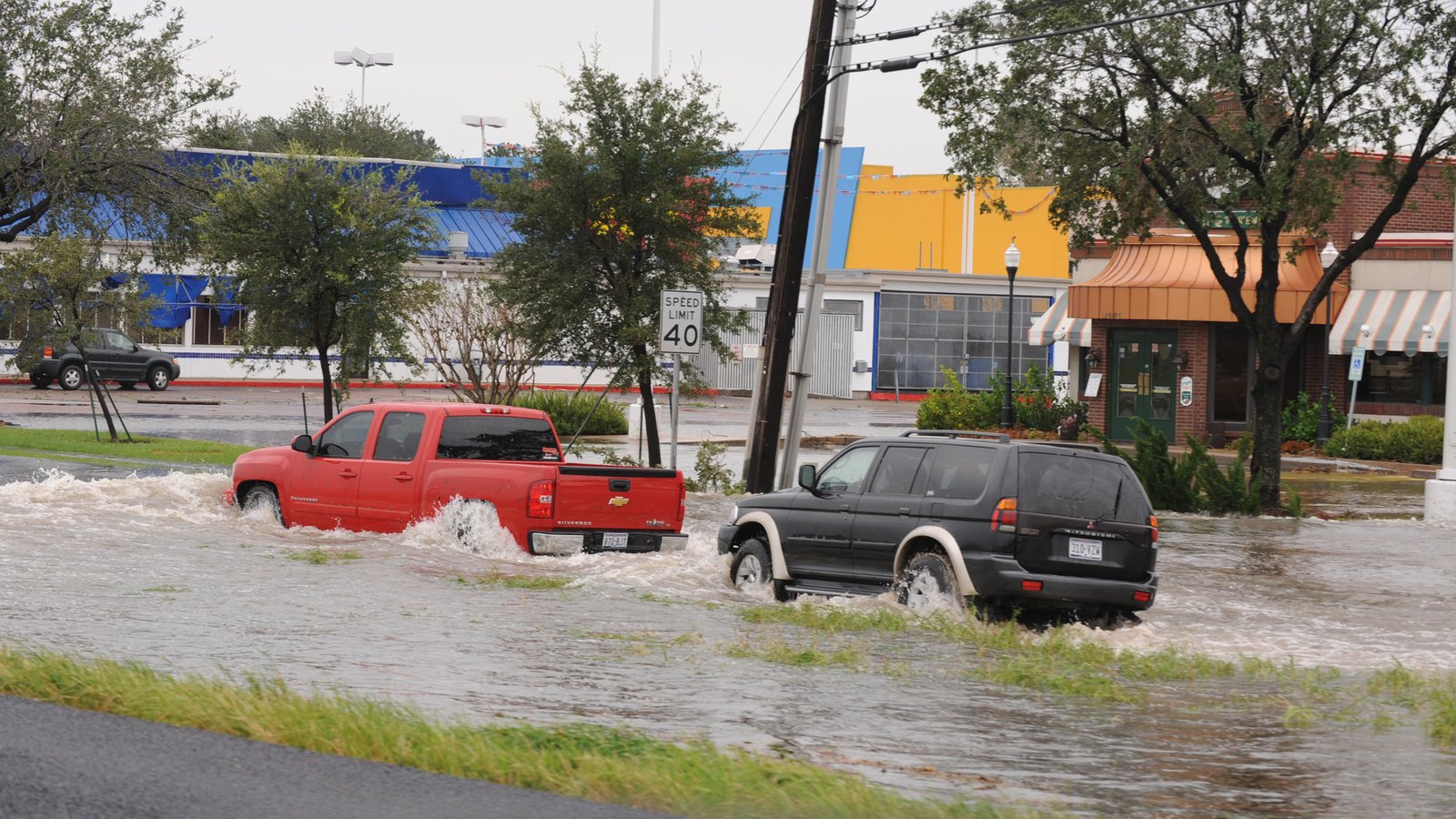 File photo: vehicles push through floodwater on a Houston street after Hurricane Ike in September 2008, not Edouard. No rights-cleared photographs of this week's Edouard flooding were available; 
